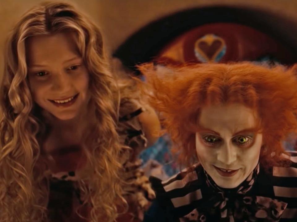 Mia Wasikowska and Johnny Depp in "Alice in Wonderland" (2010).