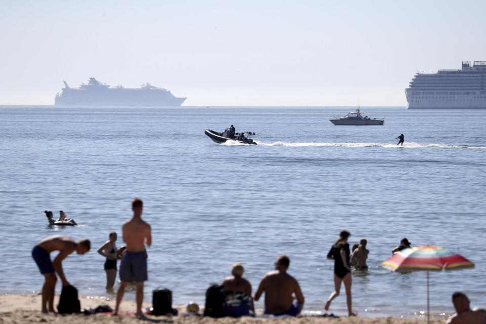 A person on a water skis off the the beach at Bournemouth, Southern England, Friday Aug. 7, 2020. The UK could see record-breaking temperatures with forecasters predicting Friday could be the hottest day of the year. (Andrew Matthews/PA via AP)