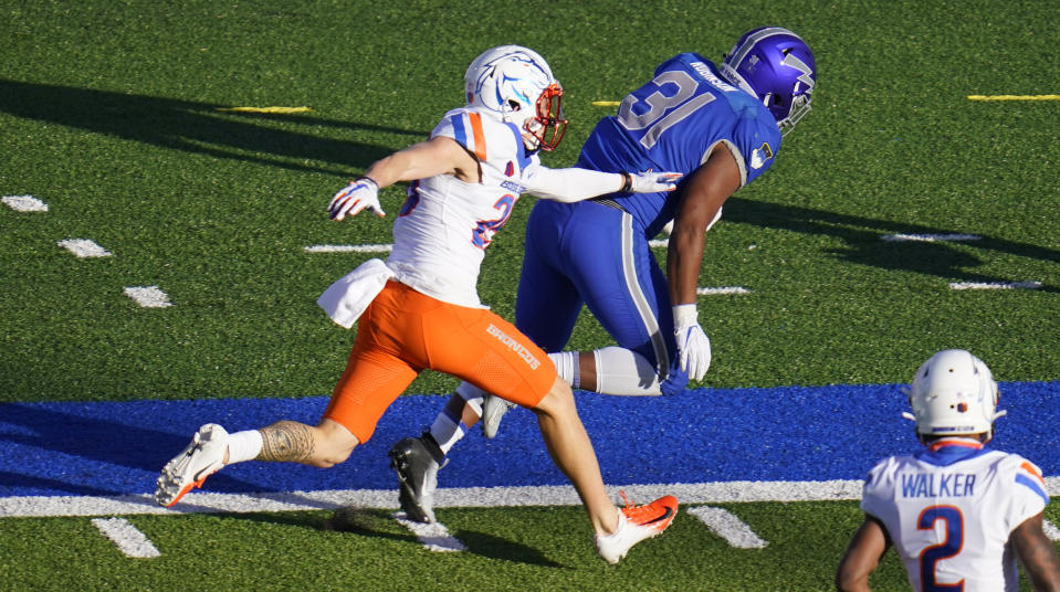 Boise State guard Kekaula Kaniho, left, pushes Air Force fullback Elijah Robinson out of bounds after a long gain in the first half of an NCAA college football game Saturday, Oct. 31, 2020, at Air Force Academy, Colo. (AP Photo/David Zalubowski)