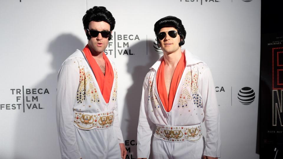 elvis presley impersonators smile for a photo