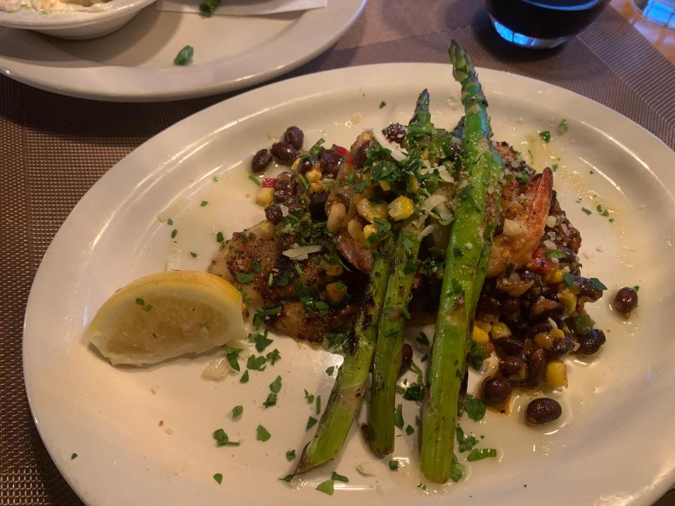 Shrimp- and crab-stuffed catfish comes with grilled asparagus and black bean mango salsa at Edgar's Restaurant in Akron.