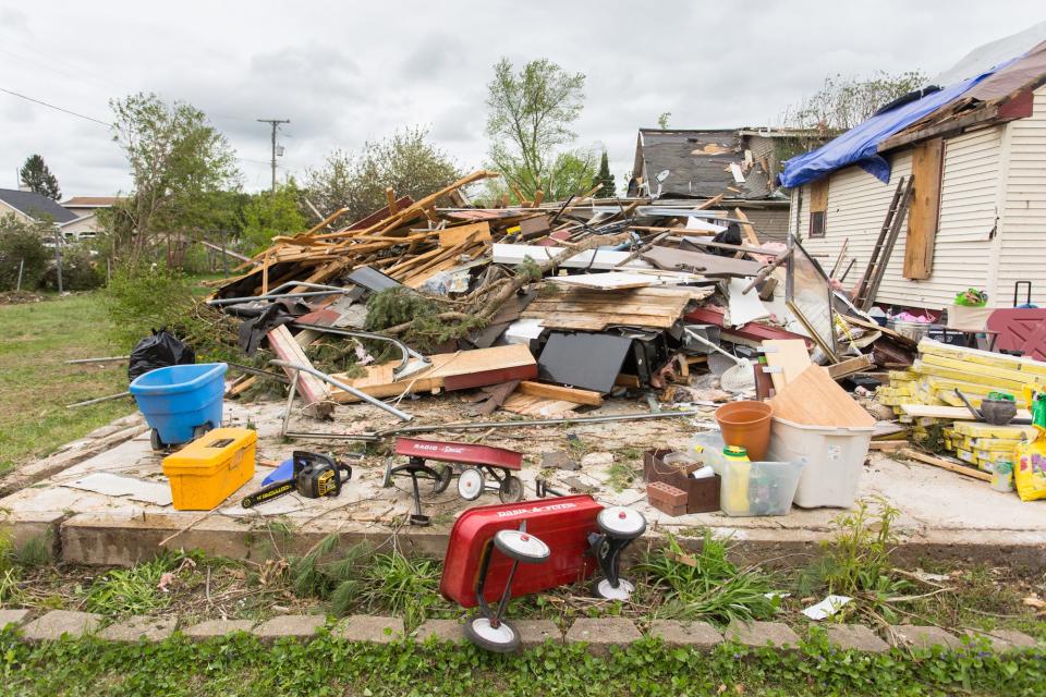 Debris lies on the ground Sunday, May 22, 2022, where a garage once stood, belonging to Steve and Theresa Haske, of Gaylord, after a tornado touched down Friday in Gaylord.