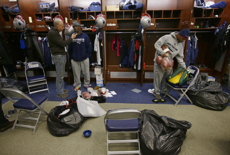 New England Patriots free safety Devin McCourty talks to a reporter, left, while standing in front of his locker as cornerback Alfonzo Dennard, right, packs up his personal items in the locker room at the NFL football team's facility in Foxborough, Mass., Monday, Jan. 20, 2014. The Patriots lost to the Denver Broncos in the AFC Championship game Sunday in Denver ending their season. (AP Photo/Stephan Savoia)