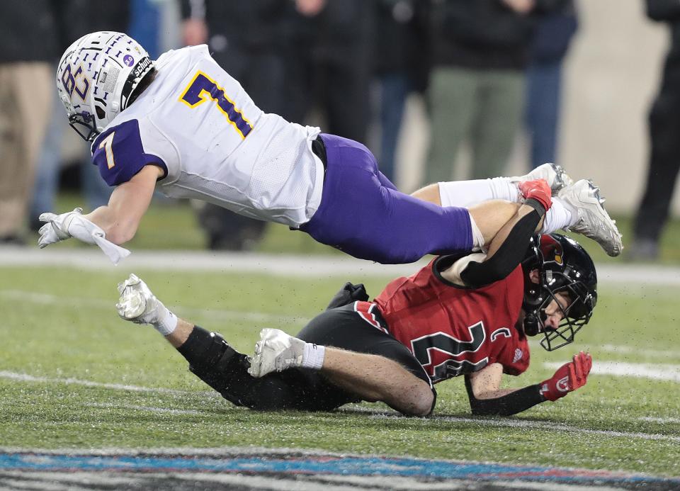 Canfield's Tyler Scharrer tackles Bloom-Carrol's Dylan Armentrout in the second half of the Division III state final at Tom Benson Hall of Fame Stadium in Canton, Friday, Dec. 2, 2022.