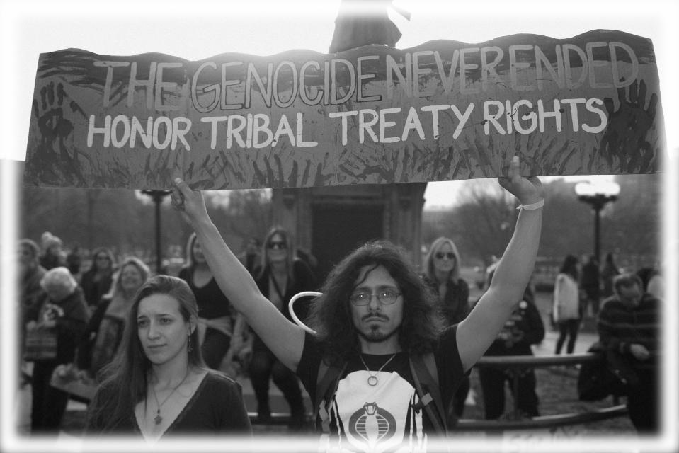 Native Americans and indigenous rights activists gather hold up a sign in protest during a Native Nations March in Denver, Colorado in 2017. (Photo: Jason Connolly/AFP/Getty Images; digitally enhanced by Yahoo News)