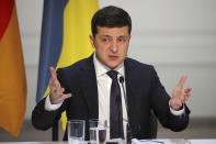 Ukraine's President Volodymyr Zelenskiy, speaks during a joint press conference with German Chancellor Angela Merkel, French President Emmanuel Macron and Russian President Vladimir Putin at the Elysee Palace in Paris, Monday Dec. 9, 2019. Russian President Vladimir Putin and Ukrainian President Volodymyr Zelenskiy met for the first time Monday at a summit in Paris to try to end five years of war between Ukrainian troops and Russian-backed separatists. (Charles Platiau/Pool via AP)