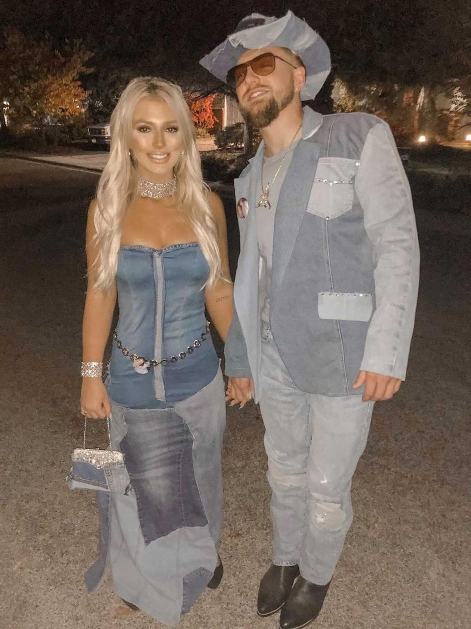 A couple dressed as Britney Spears and Justin Timberlake in their infamous all-denim looks pose for a photo.