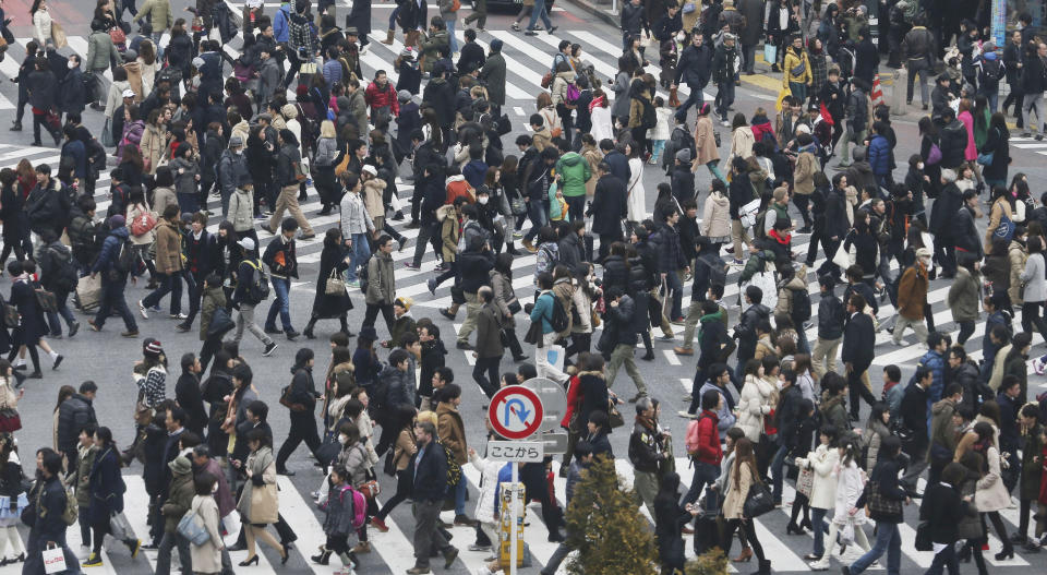 In this photo taken Jan. 25, 2014, people cross streets at Tokyo's shopping and entertainment district of Shibuya. Japan's consumer price index rose 0.4 percent in 2013, the first increase in five years, in further evidence the recovery in the world's third-largest economy is gaining momentum. (AP Photo/Koji Sasahara)