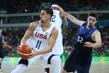 Aug 14, 2016; Rio de Janeiro, Brazil; United States guard Klay Thompson (11) controls the ball in front of France shooting guard Nando de Colo (12) during the men's preliminary round in the Rio 2016 Summer Olympic Games at Carioca Arena 1. Jeff Swinger-USA TODAY Sports