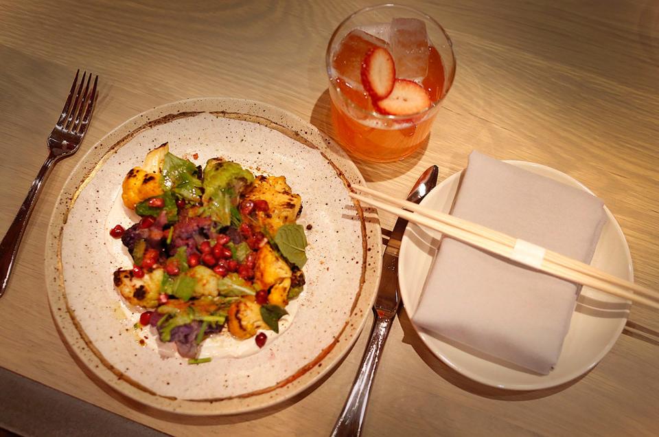 Wok-charred cauliflower, sesame yogurt, herb salad and pomegranate is on the menu at Nomai in Hingham.