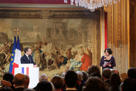 French President Emmanuel Macron (L) listens to the New Year wishes presented by Elizabeth Pineau (R), President of the Presidential Press Association (APP), at the Elysee Palace in Paris, France, January 3, 2018. REUTERS/Ludovic Marin/Pool