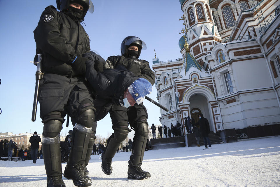 Police detain a man during a protest against the jailing of opposition leader Alexei Navalny in the Siberian city of Omsk, Russia, on Sunday, Jan. 31, 2021. Thousands of people took to the streets Sunday across Russia to demand the release of jailed opposition leader Alexei Navalny, keeping up the wave of nationwide protests that have rattled the Kremlin. Hundreds were detained by police. (AP Photo)