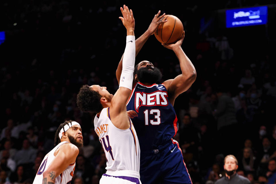 Phoenix Suns guard Landry Shamet (14) defends against Brooklyn Nets guard James Harden (13) during the first half of an NBA basketball game, Saturday, Nov. 27, 2021, in New York. (AP Photo/Jessie Alcheh)