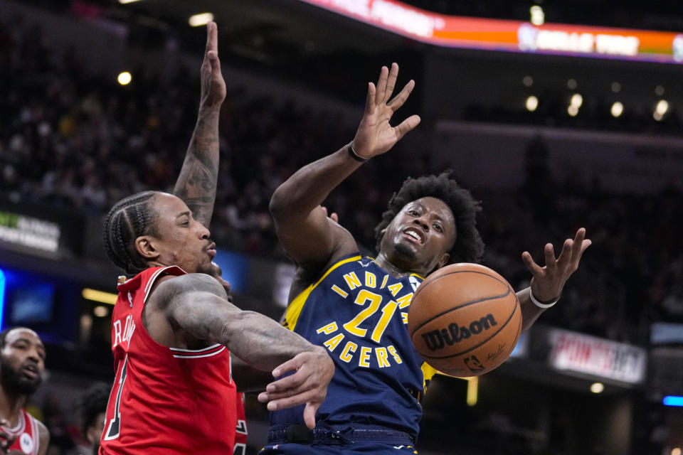 Chicago Bulls forward DeMar DeRozan (11) knocks the ball away from Indiana Pacers forward Terry Taylor (21) during the first half of an NBA basketball game in Indianapolis, Tuesday, Jan. 24, 2023. (AP Photo/Michael Conroy)