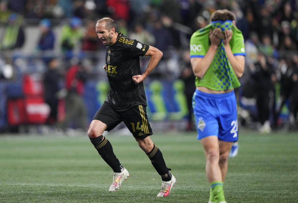 Los Angeles FC defender Giorgio Chiellini (14) reacts as the final whistle blows as Seattle Sounders midfielder Reed Baker-Whiting, right, pulls his jersey over his head as Los Angeles wins 1-0 in an MLS conference semifinal playoff soccer match Sunday, Nov. 26, 2023, in Seattle. (AP Photo/Lindsey Wasson)