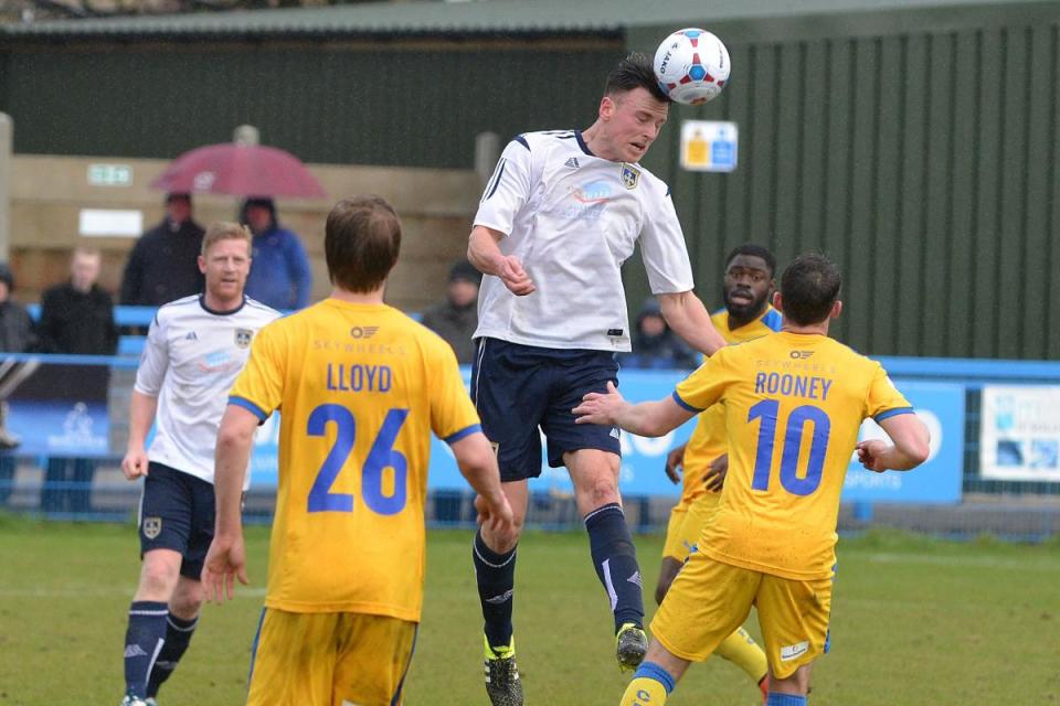 Jake Lawlor wins a header for Guiseley against Chester in a game during Mark Bower's first spell in charge at Nethermoor. <i>(Image: Richard Leach.)</i>