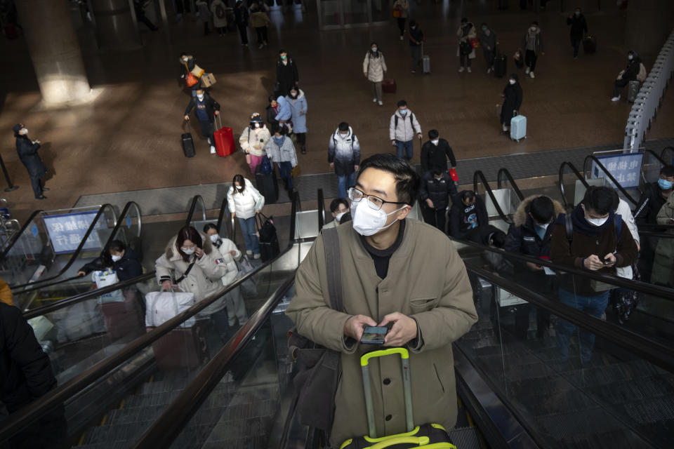 Travelers ride escalators at Beijing West Railway Station in Beijing, Wednesday, Jan. 18, 2023. China in December lifted its strict "zero-COVID" policy, letting loose a wave of pent-up travel desire, particularly around China's most important time for family gatherings, referred to in China as the Spring Festival, that may be the only time in the year when urban workers return to their hometowns. (AP Photo/Mark Schiefelbein)