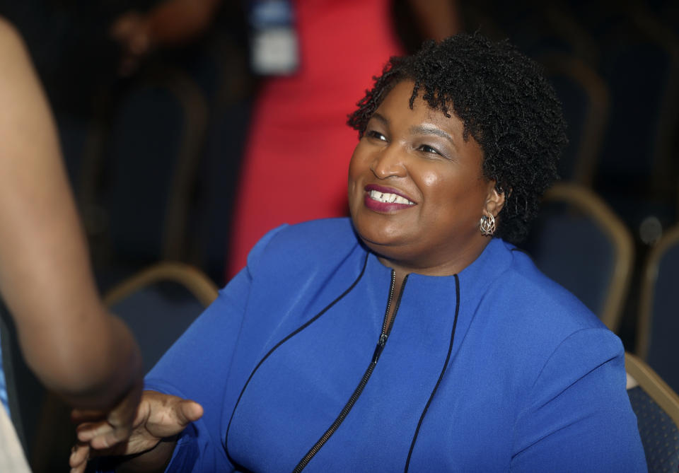 FILE- In this Aug. 3, 2018, file photo, Georgia gubernatorial candidate Stacey Abrams is greeted before speaking at the National Association of Black Journalists in Detroit. Abrams is aiming to become the nation's first black female governor. (AP Photo/Carlos Osorio, File)