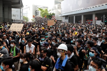 Protesters protest outside police headquarters, demanding Hong Kong’s leaders to step down and withdraw the extradition bill, in Hong Kong