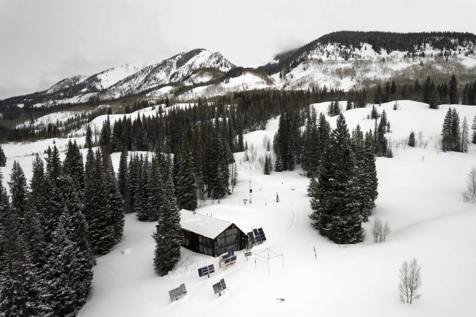 Billy Barr's solar panels and weather measuring equipment sits outside his home Thursday, March 14, 2024, in Gothic, Colo. (AP Photo/Brittany Peterson)