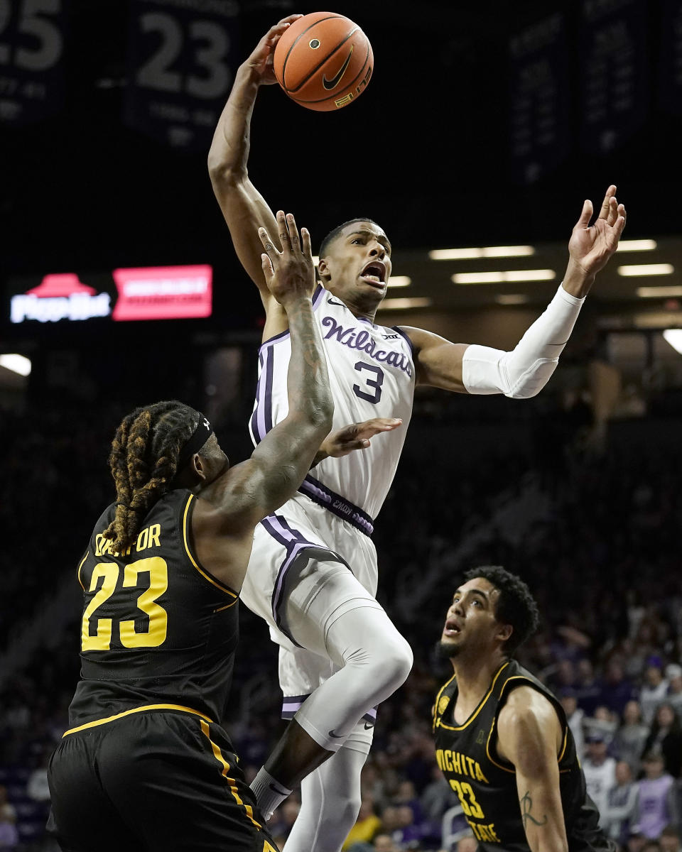 Kansas State forward David N'Guessan (3) gets past Wichita State forward Gus Okafor (23) to dunk the ball during the first half of an NCAA college basketball game against Wichita State Saturday, Dec. 3, 2022, in Manhattan, Kan. (AP Photo/Charlie Riedel)