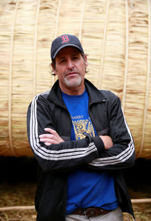 Phil Buck, a 51-year-old explorer from the United States, poses for a picture in front of the 'Viracocha III', a boat made only from the totora reed, which he will captain on a journey expected to last six months, crossing the Pacific from Chile to Australia, in La Paz, Bolivia, October 19, 2016. REUTERS/David Mercado