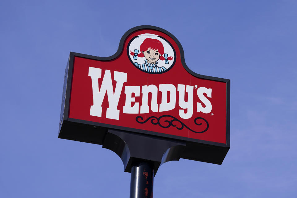 FILE - A sign stands over a Wendy's restaurant, Feb. 25, 2021, in Des Moines, Iowa. Food ads have long made their subjects look bigger, juicier and crispier than they are in person. But some consumers say those mouthwatering ads can cross the line into deception, and that’s leading to a growing number of lawsuits. Burger King is the latest company in the crosshairs. While the case against Burger King was filed in Miami, one of the attorneys who filed it has similar cases pending in New York against Wendy’s, McDonald’s and Taco Bell. (AP Photo/Charlie Neibergall, File)