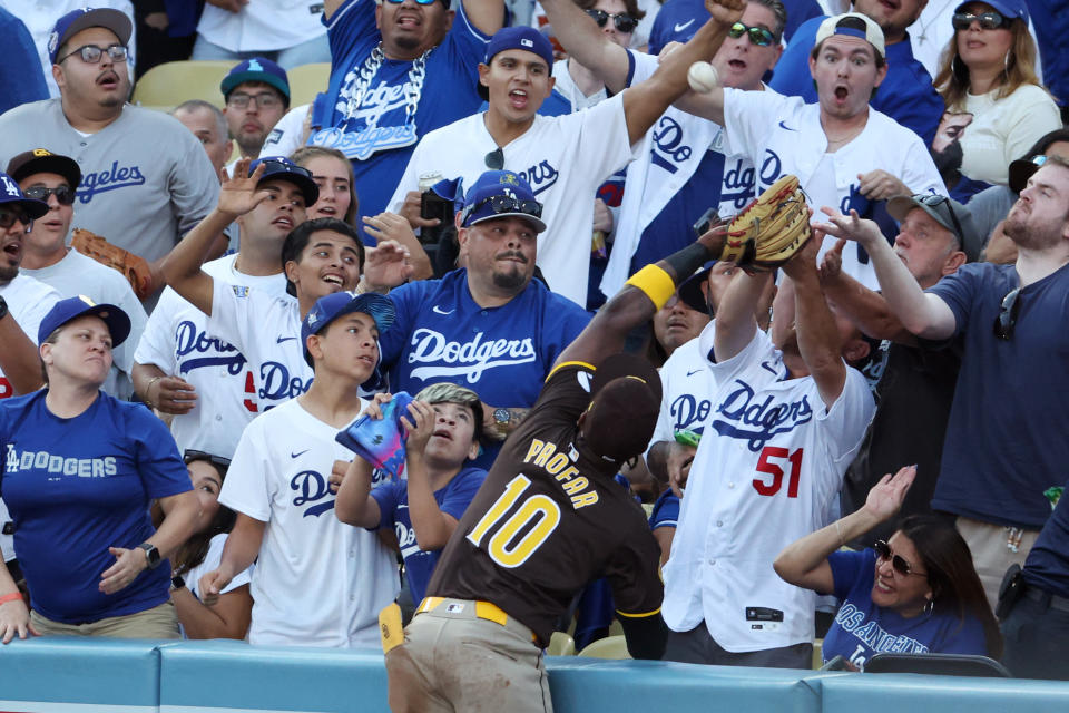 Jurickson Profar reaches into the stands to rob Mookie Betts of a home run. (Kiyoshi Mio-Imagn Images)