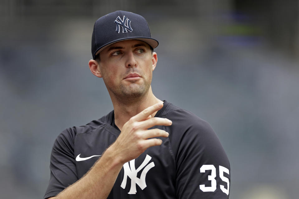 New York Yankees pitcher Clay Holmes speaks to a reporter on the field before the first baseball game of a doubleheader against the Los Angeles Angels on Thursday, June 2, 2022, in New York. The 29-year-old right-hander has gone from worst to first in the standings and from off the big league roster to a possible All-Star appearance. (AP Photo/Adam Hunger)