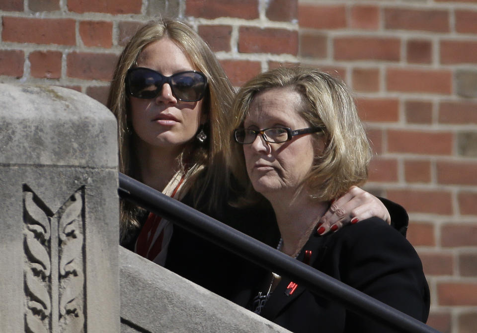 Kathy Crosby-Bell, right, mother of Boston firefighter Michael R. Kennedy, walks up the steps of Holy Name Church for her son's funeral in Boston, Thursday, April 3, 2014. Kennedy and Boston Fire Lt. Edward J. Walsh were killed Wednesday, March 26, 2014 when they were trapped in the basement of a burning brownstone during a nine-alarm blaze.(AP Photo/Stephan Savoia)