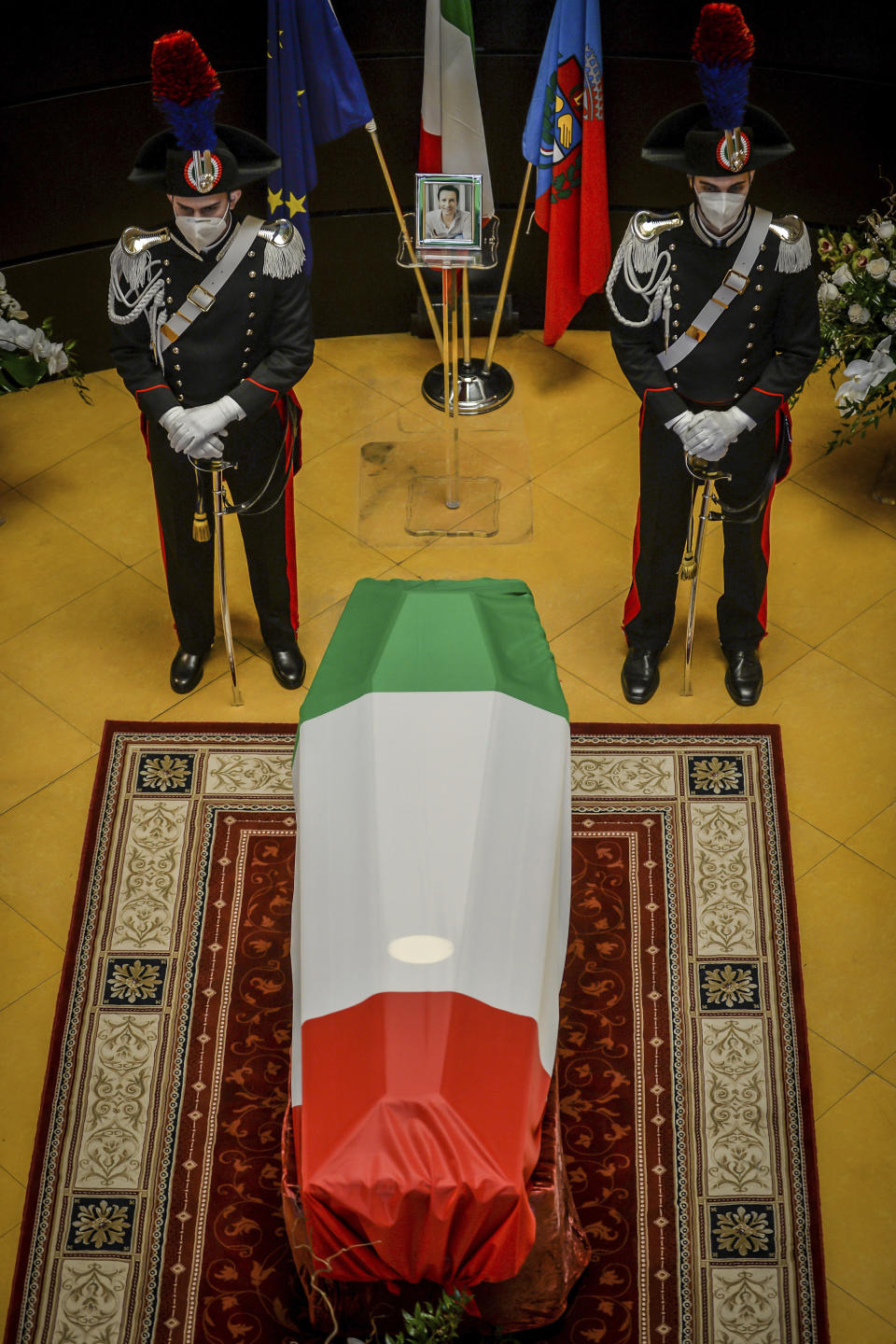 Carabinieri officers stand by the coffin of Italian ambassador to the Democratic Republic of Congo Luca Attanasio, in Limbiate, near Milan, Italy, Friday, Feb. 26, 2021. Italy paid tribute to its ambassador to Congo and his bodyguard who were killed in an attack on a U.N. convoy, honoring them with a state funeral Thursday. (Claudio Furlan/LaPresse via AP)