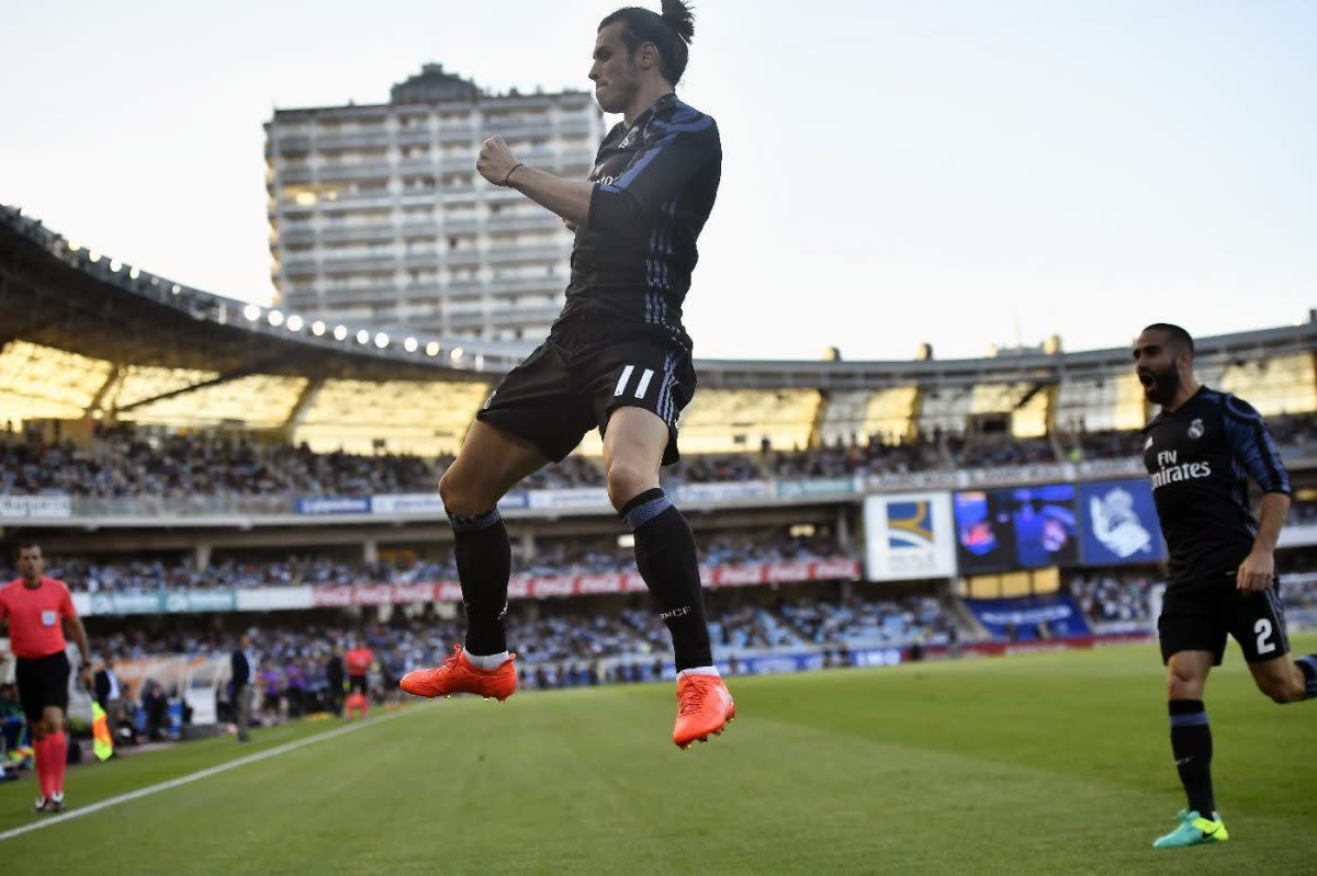 Real Madrid's Gareth Bale (11) leaps in celebration after scoring against Real Sociedad on Sunday. (AP)