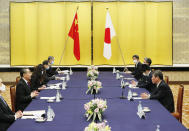 China' Foreign Minister Wang Yi, second left, meets with his Japanese counterpart Toshimitsu Motegi, right, amid the coronavirus outbreak, in Tokyo on Tuesday, Nov. 24, 2020. Wang met Motegi on Tuesday to discuss ways to revive their pandemic-hit economies as well as regional concerns over China’s growing influence. (Issei Kato/Pool Photo via AP)