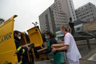 Carrero Castano, a delivery man for the Spanish postal service ÒCorreosÓ, delivers 20 pizzas to medical staff at La Paz Hospital as part of the Food4Heroes initiative during the outbreak of coronavirus disease (COVID-19) in Madrid