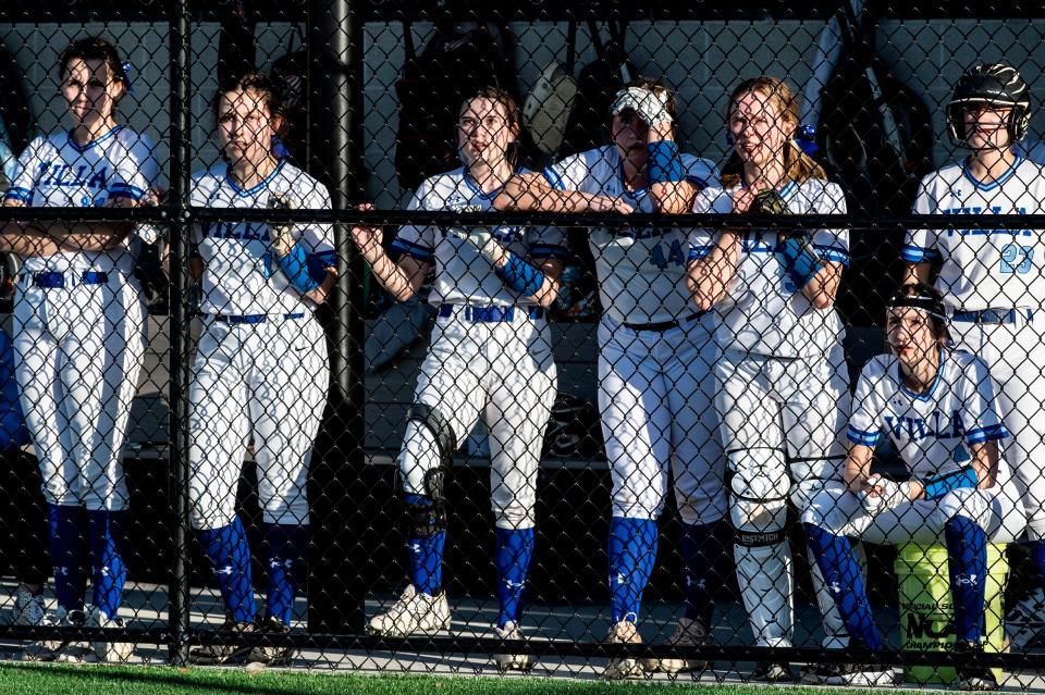 Villa Maria team members watch the game from the dugout on April 12 while playing McDowell at the Mercyhurst University softball field.