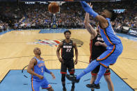 Oklahoma City Thunder center Nerlens Noel, right, dunks in front of teammate Chris Paul (3) and Miami Heat forwards Jimmy Butler (22) and Meyers Leonard, behind Noel, during the first half of an NBA basketball game Friday, Jan. 17, 2020, in Oklahoma City. (AP Photo/Sue Ogrocki)