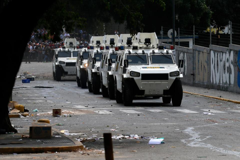 Bolivarian National Guard armored vehicles arrive during clashes between anti-government protesters and motorcyclists in the Los Ruices neighborhood of Caracas, Venezuela, Thursday, March 6, 2014. Venezuelan officials say a National Guard member and a civilian were killed in the clash between residents and armed men who tried to remove a barricade placed by anti-government protesters. (AP Photo/Fernando Llano)