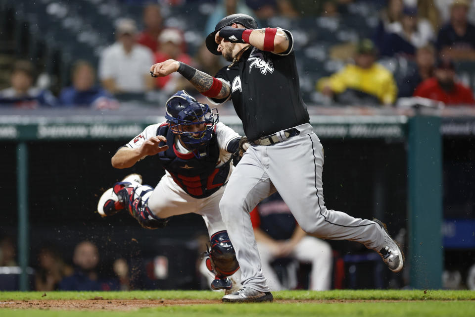 Cleveland Guardians catcher Luke Maile, left, tags out Chicago White Sox's Yasmani Grandal attempting to score on a single by Elvis Andrus during the seventh inning of a baseball game Saturday, Aug. 20, 2022, in Cleveland. (AP Photo/Ron Schwane)