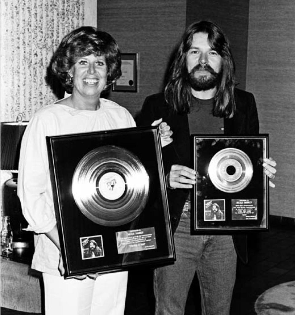 Rosalie Trombley, left, with Bob Seger and gold-record plaques for his 1978 album "Stranger in Town."