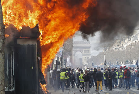 A burning newsagent's shop is seen during a demonstration by the "yellow vests" movement in Paris, March 16, 2019
