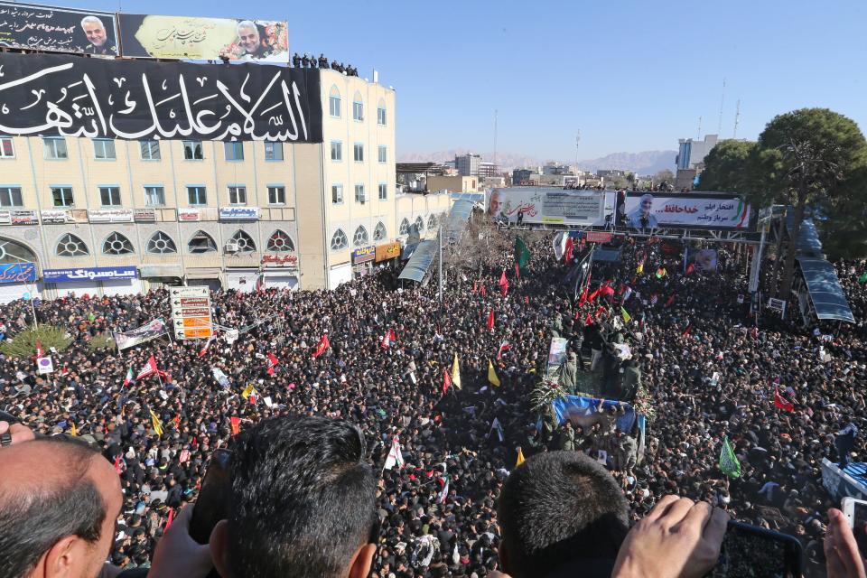 Iranian mourners gather around a vehicle carrying the coffin of slain top general Qasem Soleimani during the final stage of funeral processions, in his hometown Kerman on January 7, 2020. - Soleimani was killed outside Baghdad airport on January 3 in a drone strike ordered by US President Donald Trump, ratcheting up tensions with arch-enemy Iran which has vowed "severe revenge". The assassination of the 62-year-old heightened international concern about a new war in the volatile, oil-rich Middle East and rattled financial markets. (Photo by ATTA KENARE / AFP) (Photo by ATTA KENARE/AFP via Getty Images)