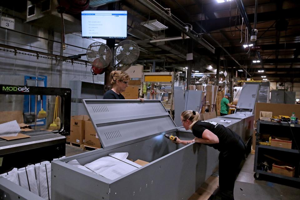 Workers from Spacesaver Corporation assemble an evidence storage locker on Tuesday, Sept. 27, 2022 in Fort Atkinson.