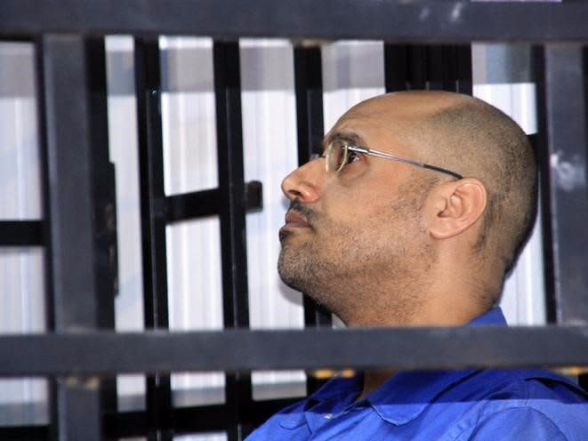 Saif al-Islam Gaddafi, son of late Libyan leader Muammar Gaddafi, attends a hearing behind bars in a courtroom in Zintan May 25, 2014. REUTERS/Stringer