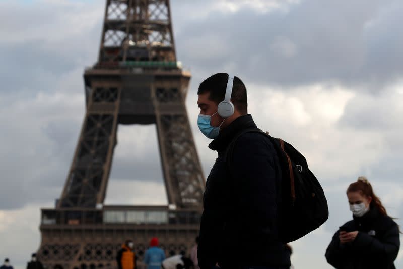 People wear protective face masks in Paris