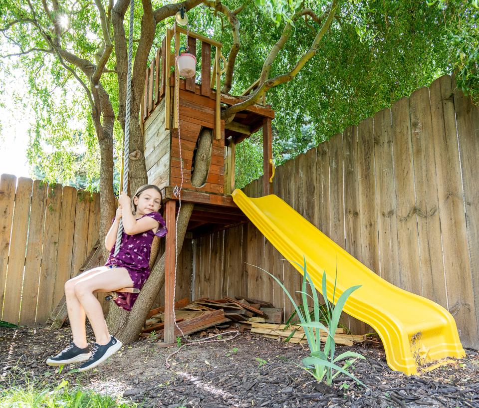 Rhyen Clarke, 7, plays in a custom tree house built by her dad, Troy Clarke, at their home in Milwaukee.