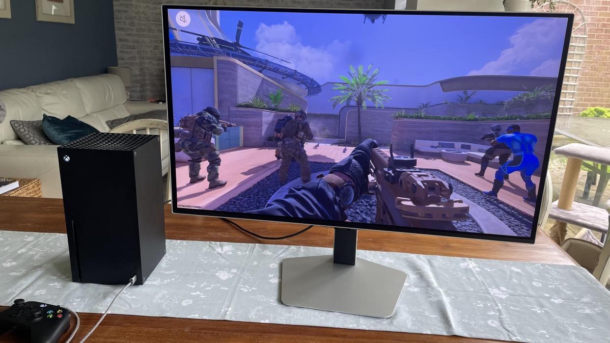  The Samsung S32G80SD sat on a table alongside an Xbox Series X. 