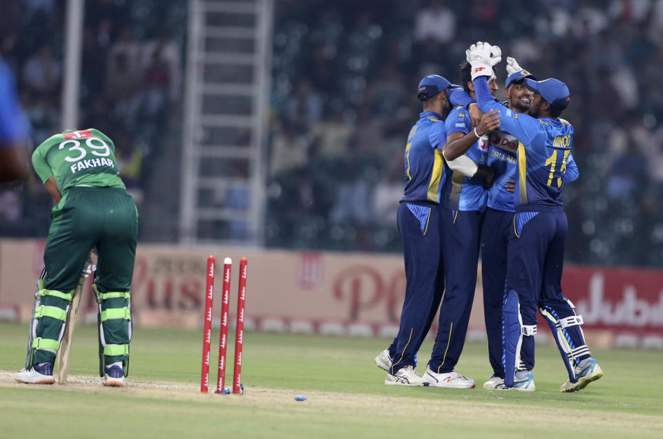 Sri Lankan players celebrate the dismissal of Pakistani batsman Fakhar Zaman during the second Twenty20 match between Pakistan and Sri Lanka in Lahore, Pakistan, Monday, Oct. 7, 2019. Sri Lanka won the toss and elected to bat in the second Twenty20 against Pakistan. (AP Photo/K.M. Chaudary)