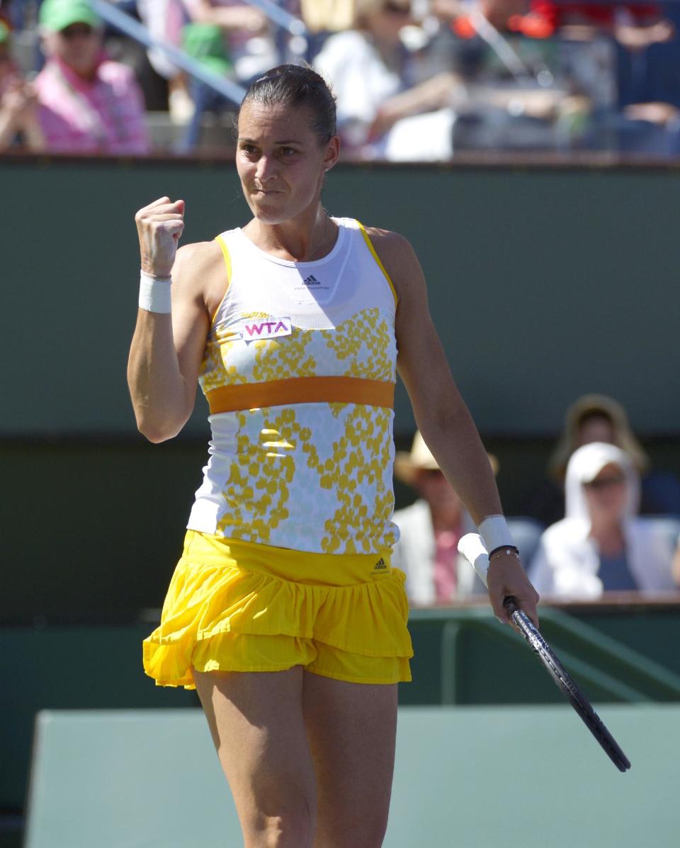 Flavia Pennetta, of Italy, celebrates after winning the first set of her finals match to Agnieszka Radwanska, of Poland, at the BNP Paribas Open tennis tournament, Sunday, March 16, 2014, in Indian Wells, Calif. (AP Photo/Mark J. Terrill)