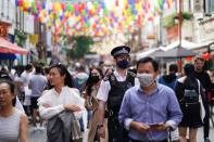 People walk through the Chinatown area, amid the coronavirus disease (COVID-19) outbreak, in London