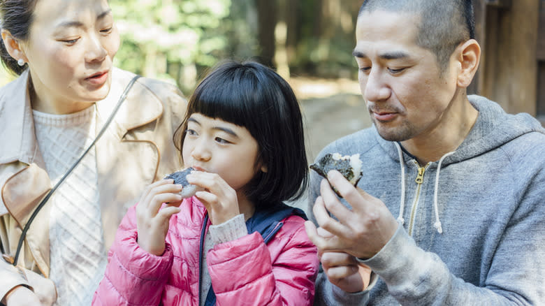 Family eating umeboshi onigiri together